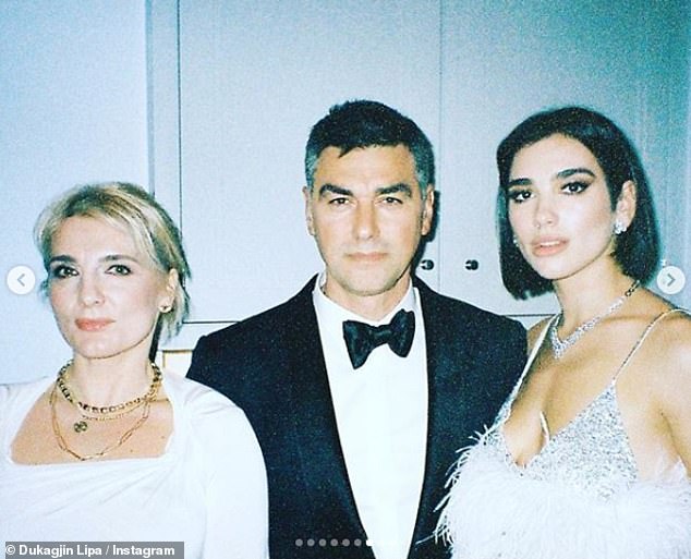 Family first: Meanwhile, the award-winning singer revealed her immigrant background encourages her to make a difference in the world (pictured with her Albanian parents)