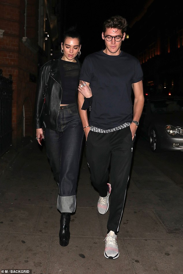 Sweet: Dua Lipa looked smitten with beau Isaac Carew as the couple headed out for a dinner date at Nobu Berkeley in London on Friday... after fans went wild for singer's hunky father