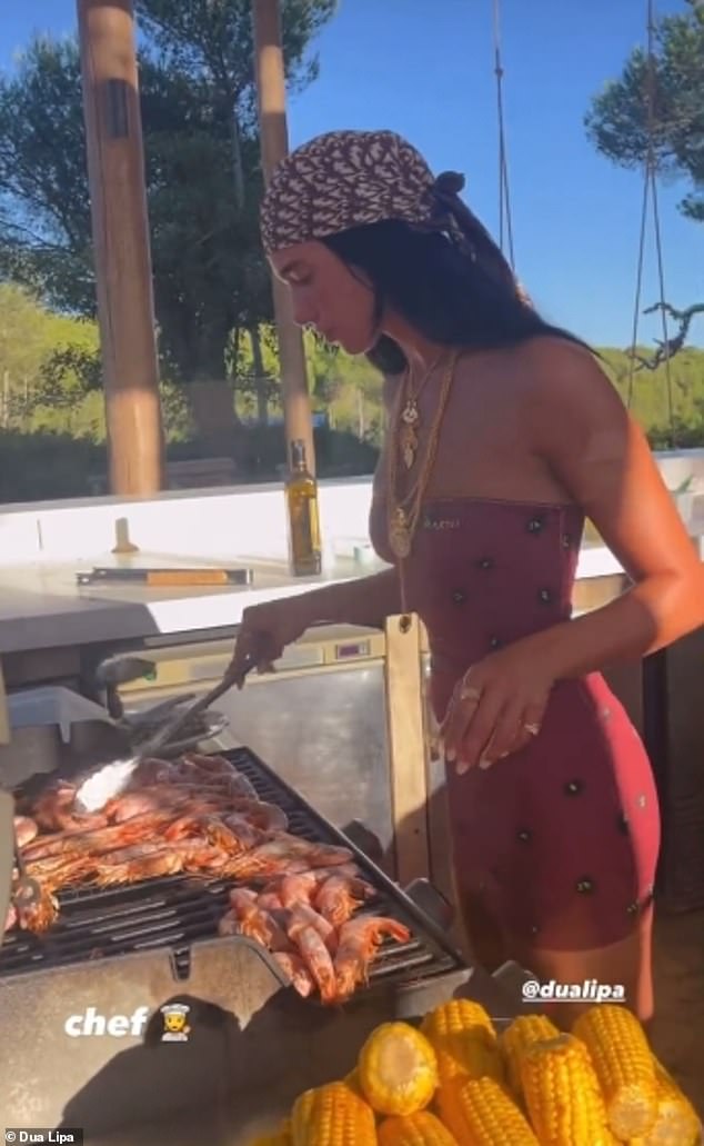 'Chef': The Levitations hitmaker, 28, looked incredible as she showed off her sensational figure in a strapless red minidress while standing over a grill