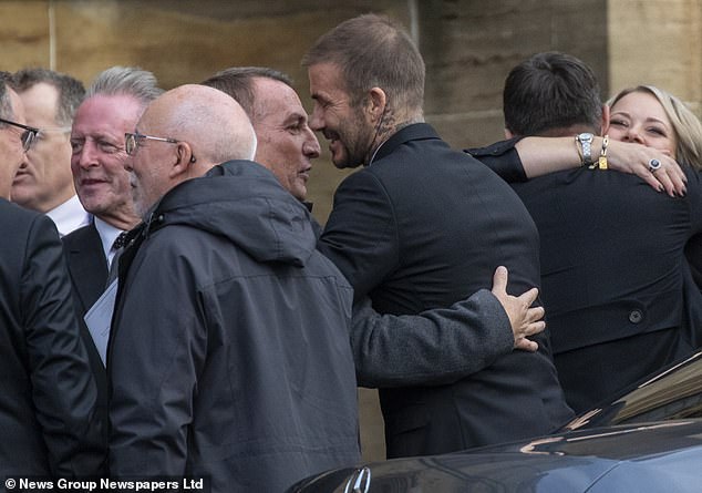 Beckham and Rodgers took time to greet one another as mourners mingled outside the church