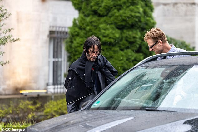 Casual: The actor continued to sport wet hair during the outing as he headed to a waiting car after being greeted by a crew member