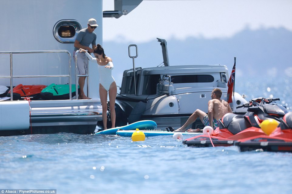 Watchful eye: She balanced on the board as her nearby pals kept a watchful eye over her