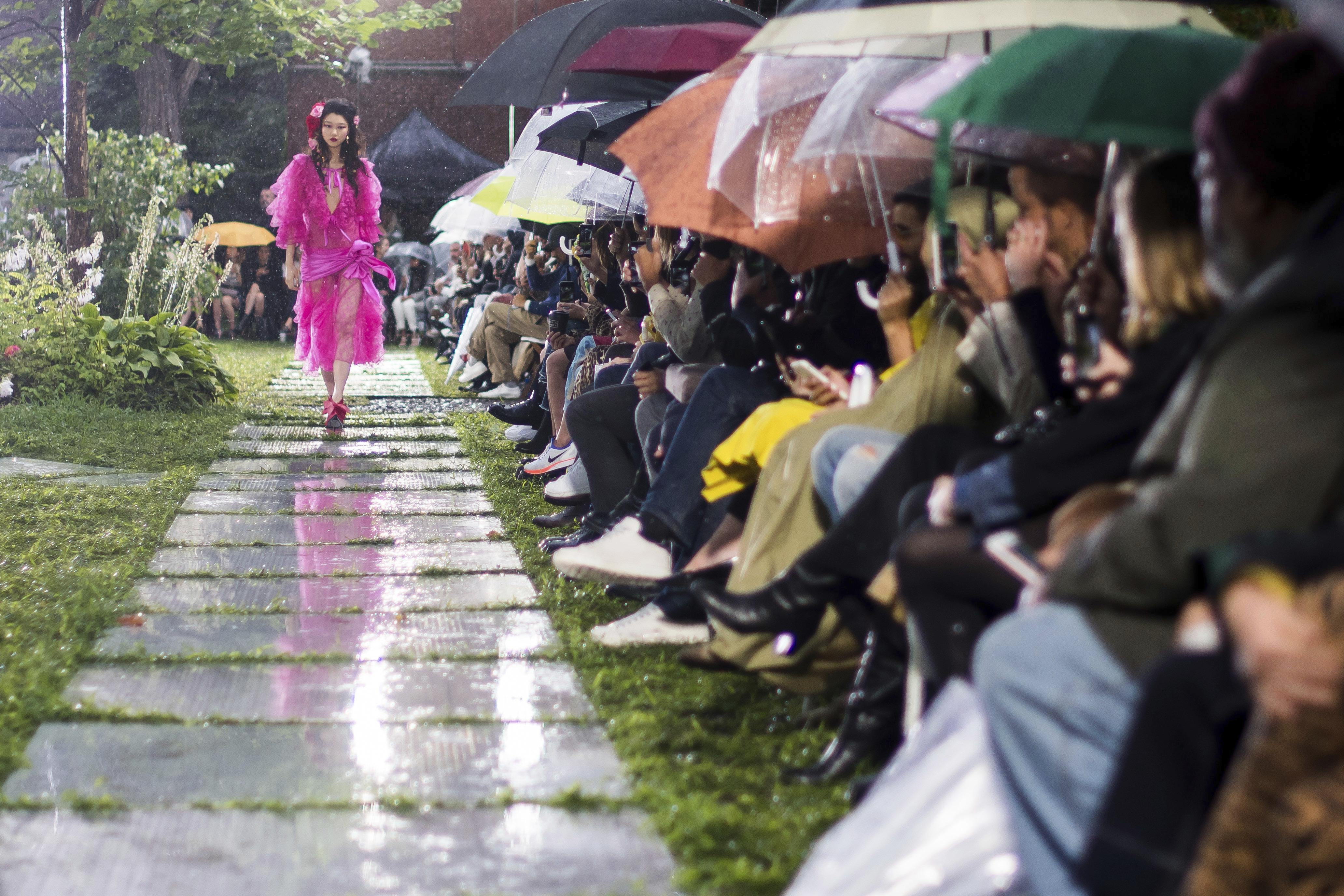  Those lucky enough to bag a front row seat at Rodarte's show had to whip out the brollies